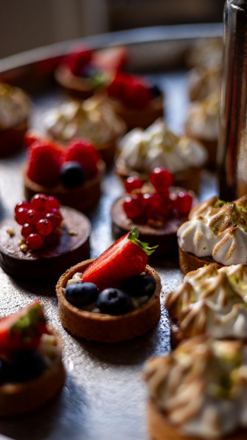 Free Close-up of assorted mini tartlets topped with fresh berries and meringue. Stock Photo