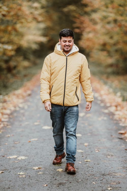 Man in Yellow Warm Jacket Walking in Autumnal Forest · Free Stock Photo