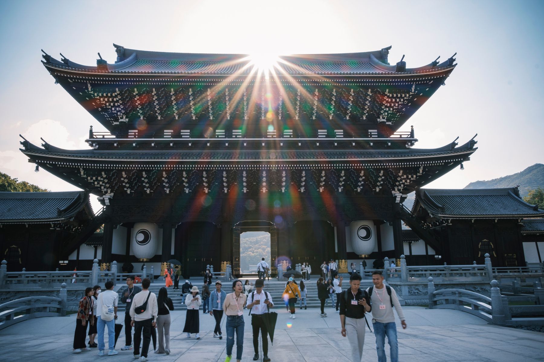 Visitors exploring traditional temple architecture in Kyoto, Japan
