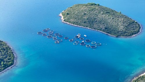 Free Stunning aerial view of fish farms near islands in Zadar's turquoise waters. Stock Photo