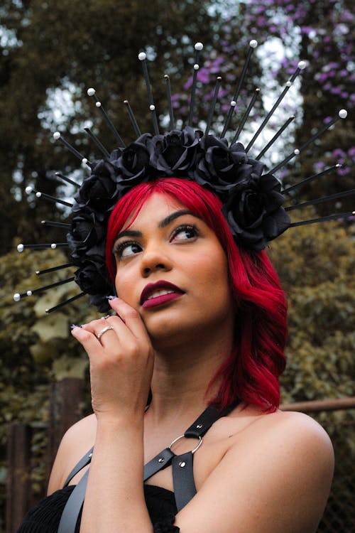 Young Woman with Red Hair Wearing a Crown with Black Flowers