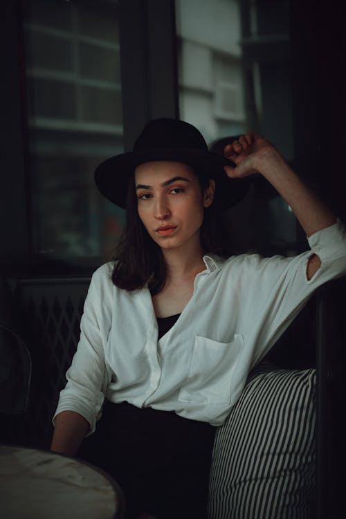Young Elegant Woman in a White Shirt and Hat 