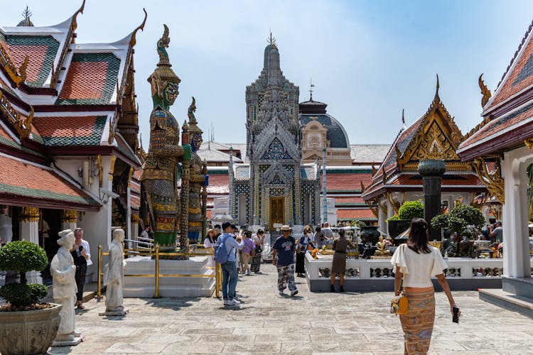 People Walking Near Traditional Buddhist Temple