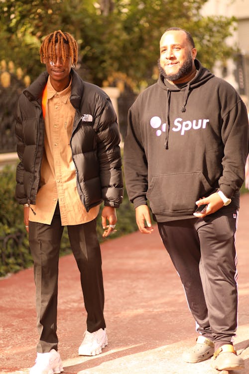 Street shot of 2 men walking and laughing · Free Stock Photo