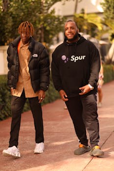 Two stylish friends enjoying a sunny walk in Miami Beach, showcasing modern street fashion.