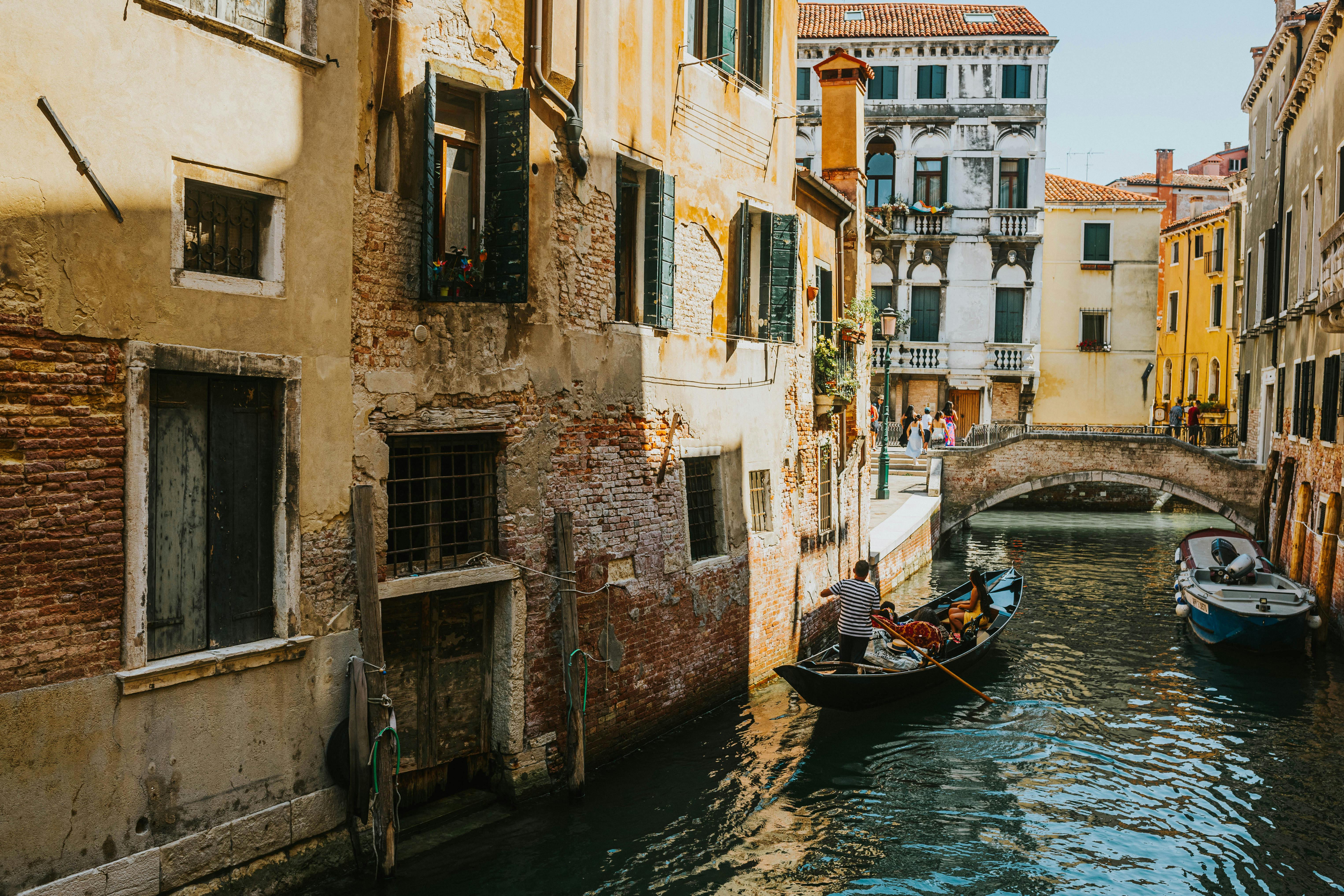 Charming view of a gondola navigating a Venetian canal surrounded by historic buildings.