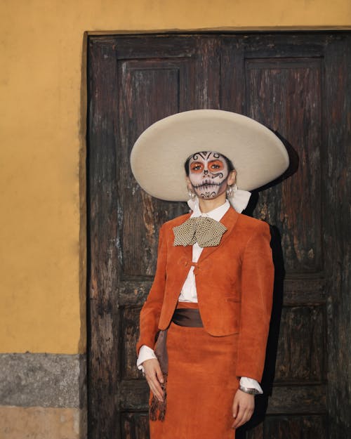 Person in Sombrero and Leather Suit in Halloween Makeup