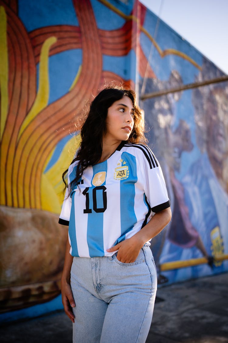 Brunette Woman In Argentinian Football Shirt Holding Hand In Jeans Pocket