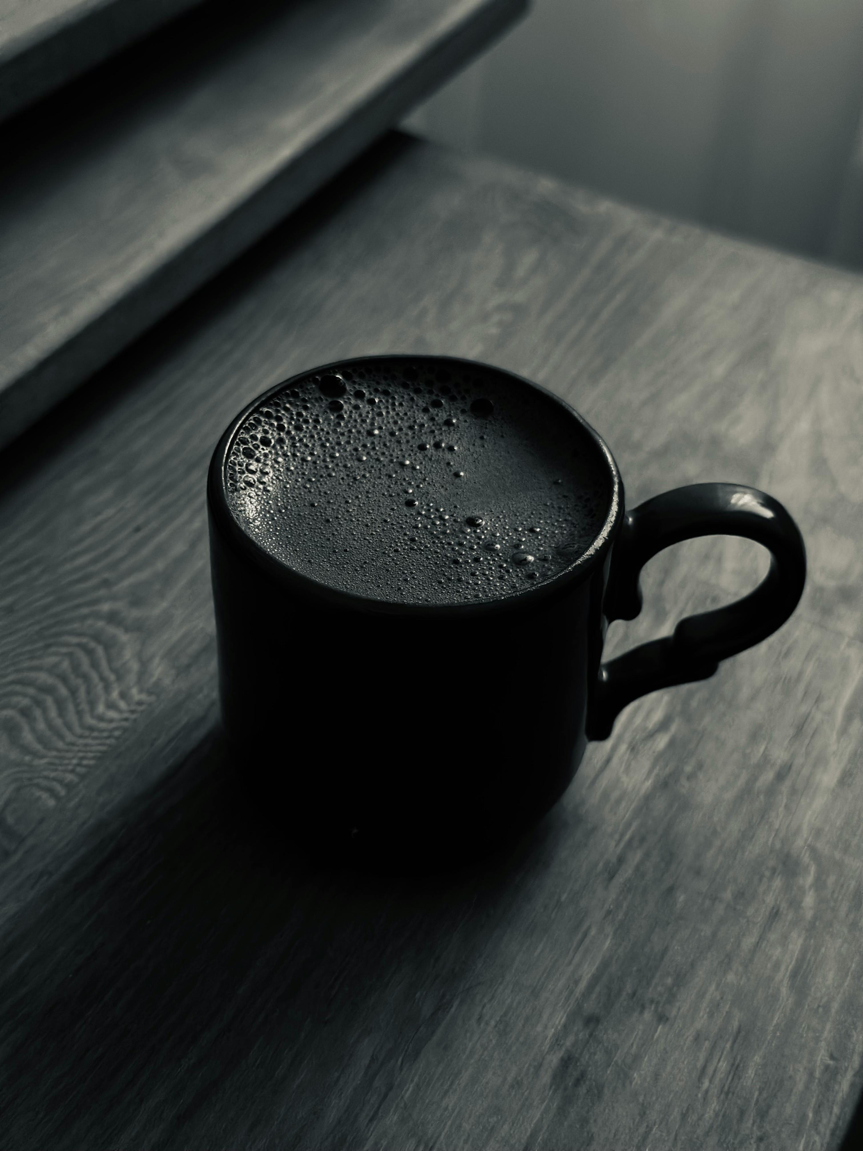 Fresh brewed coffee in a mug on a wooden table