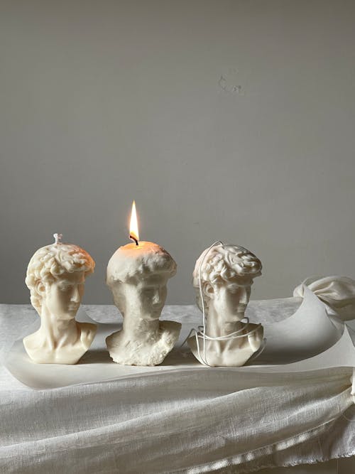 Wax Busts with Burning Candle