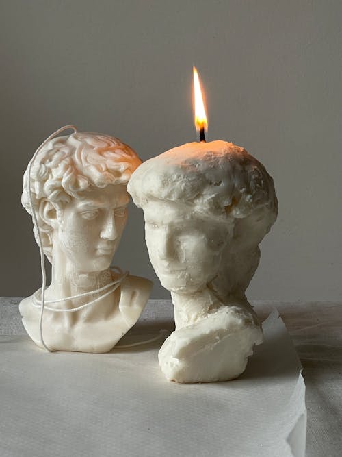 Wax Busts and Burning Candle