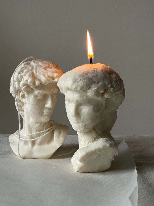 Free Close-up of a classical bust candle with a burning flame enhancing the artistic sculpture. Stock Photo