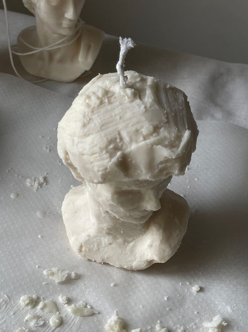 Free Handcrafted candle resembling a classical bust sculpture, set in soft indoor light. Stock Photo