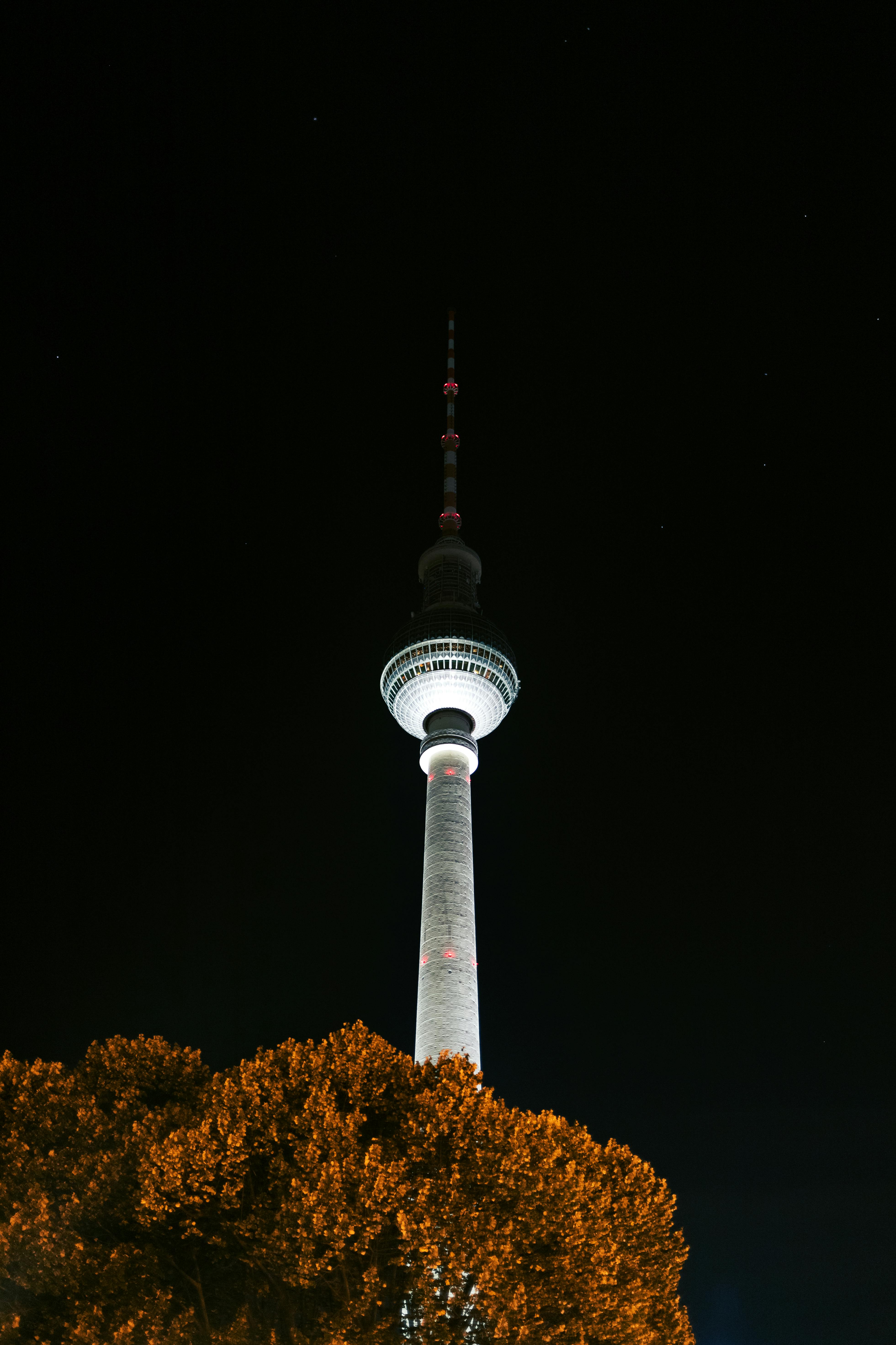 Stunning night view of the illuminated Berliner Fernsehturm, a famous landmark in Berlin, Germany.
