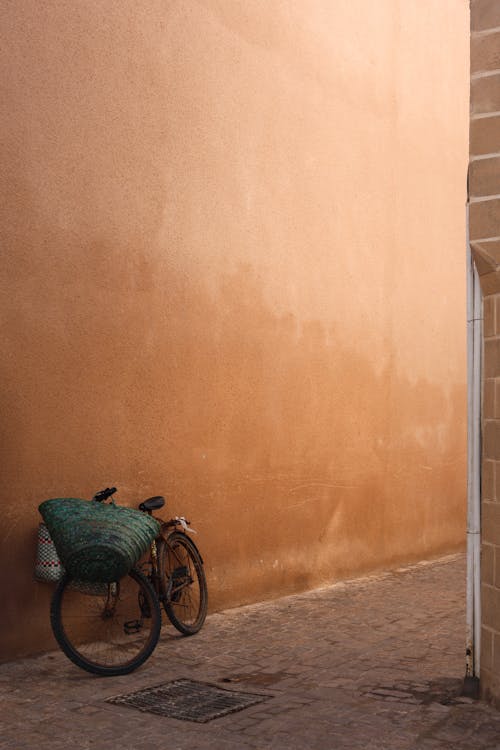 Bike near Building Wall on Paved Street