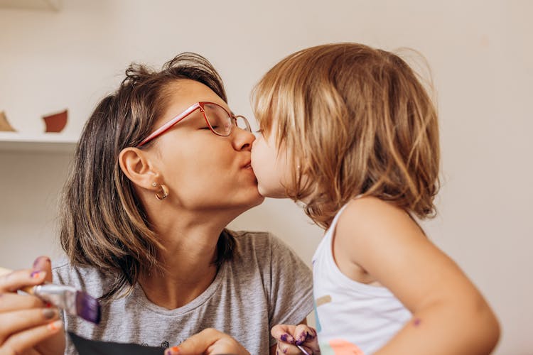 Mother And Daughter Kissing