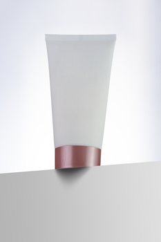 Close-up of a cosmetic skincare tube with a minimalist design on a white background.