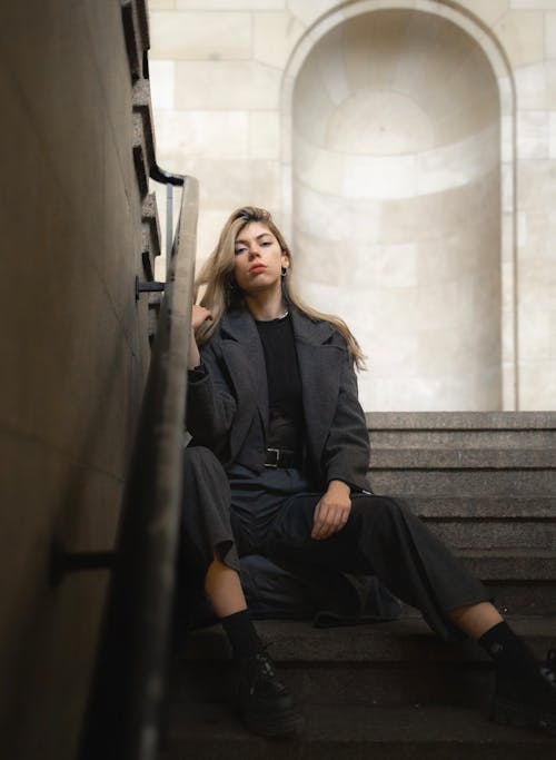 Woman in a Gray Suit Sitting on the Steps 