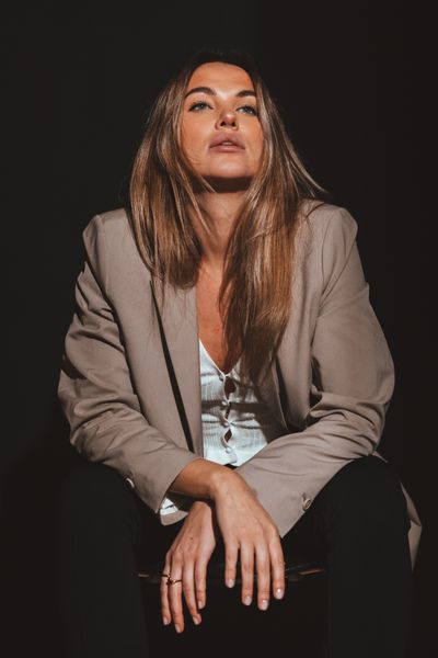 Studio portrait of a woman in a blazer — photo by Mario W. on Pexels