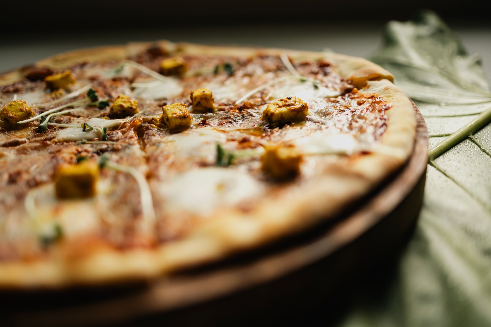 Tandoori chicken topped Indian fusion pizza fresh from oven