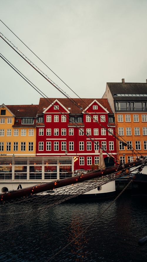 Free Scenic view of Nyhavn's colorful buildings and a moored ship in Copenhagen, Denmark. Stock Photo