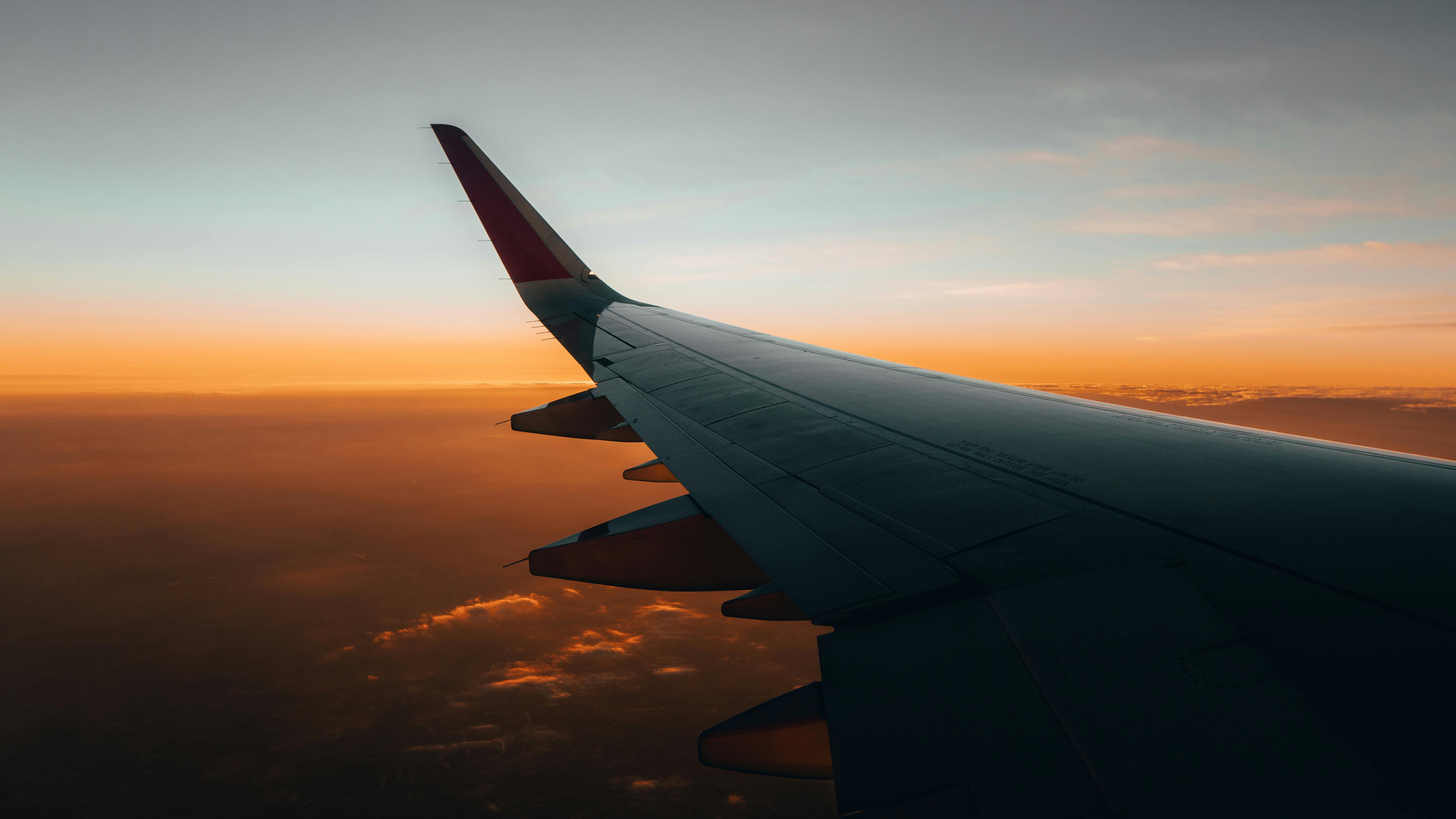 View of an aeroplane wing above the clouds during a sunset flight