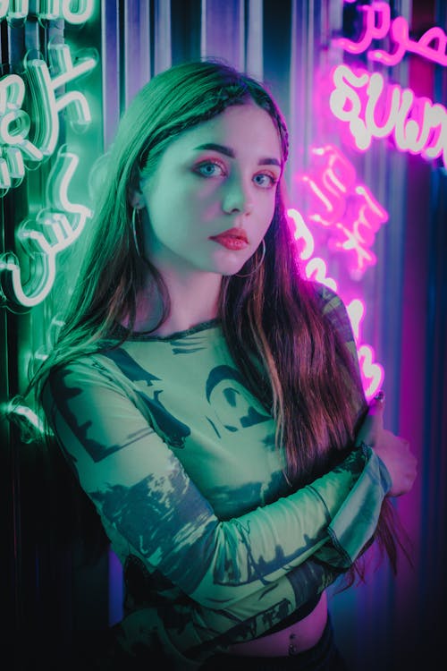 Teenage Model Posing in Blouse against Neons · Free Stock Photo
