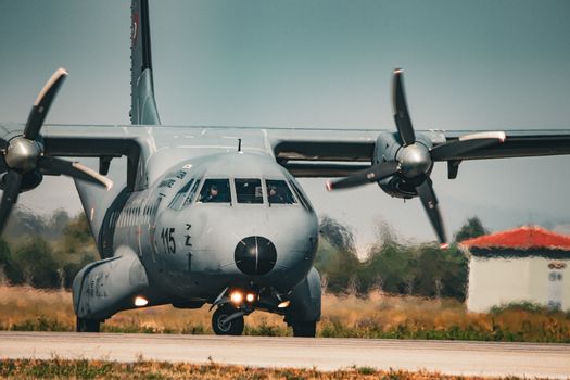 A military aircraft taxiing on a sunny runway in İzmir, Türkiye.