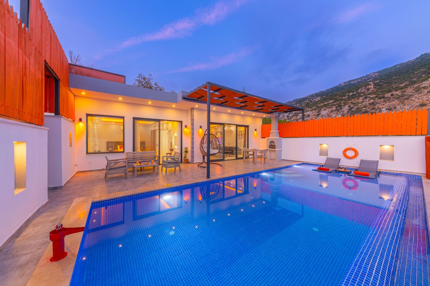 Modern resort pool under a twilight sky