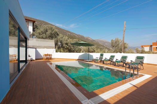 Relax at a luxurious villa with mountain-view pool and sun loungers.
