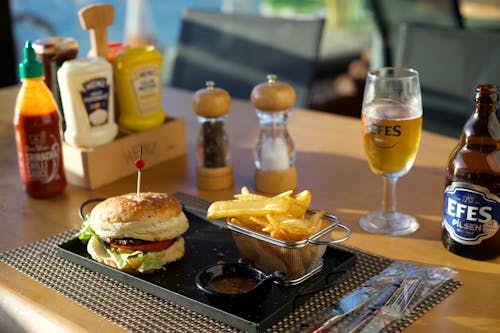 Burger with Fries and a Beer on the Table 