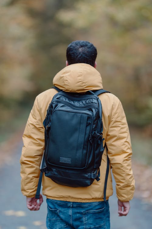 Back View of a Man in a Jacket Wearing a Backpack 