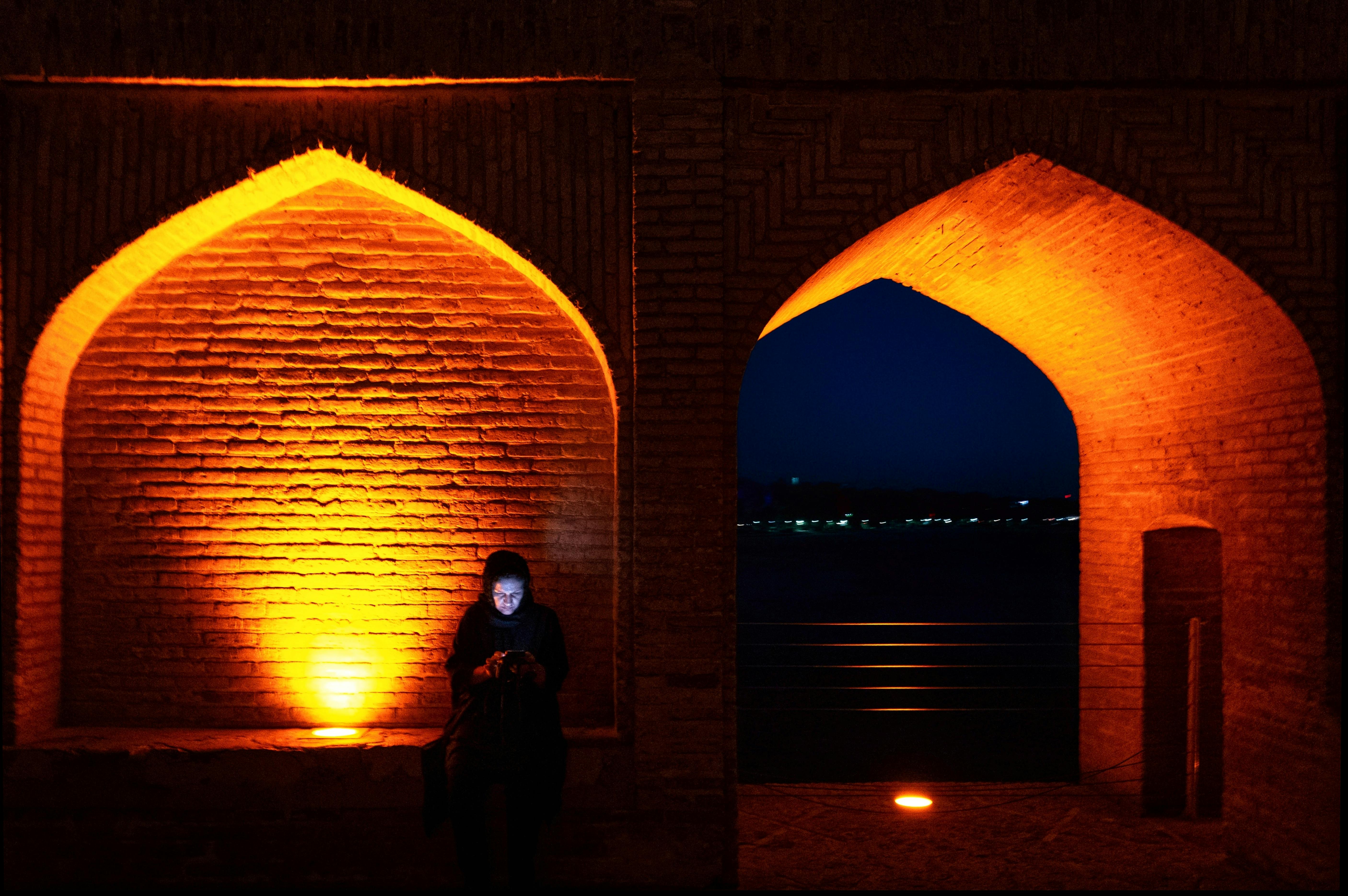 illuminated arch bridge in isfahan at dusk