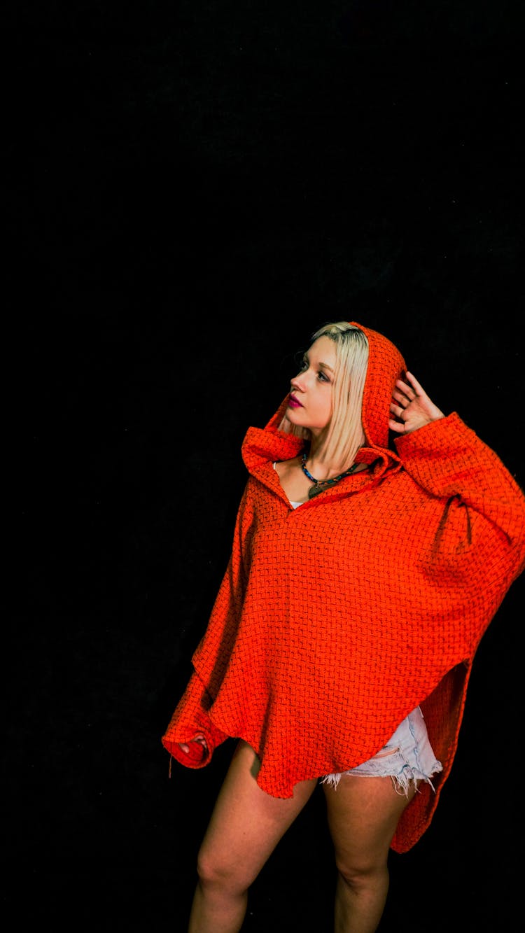 Blonde Woman Standing In Red Poncho