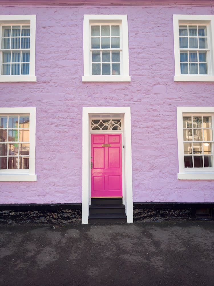 Pink Door Of A House With Lilac Colored Wall In Kirkcudbright, Scotland