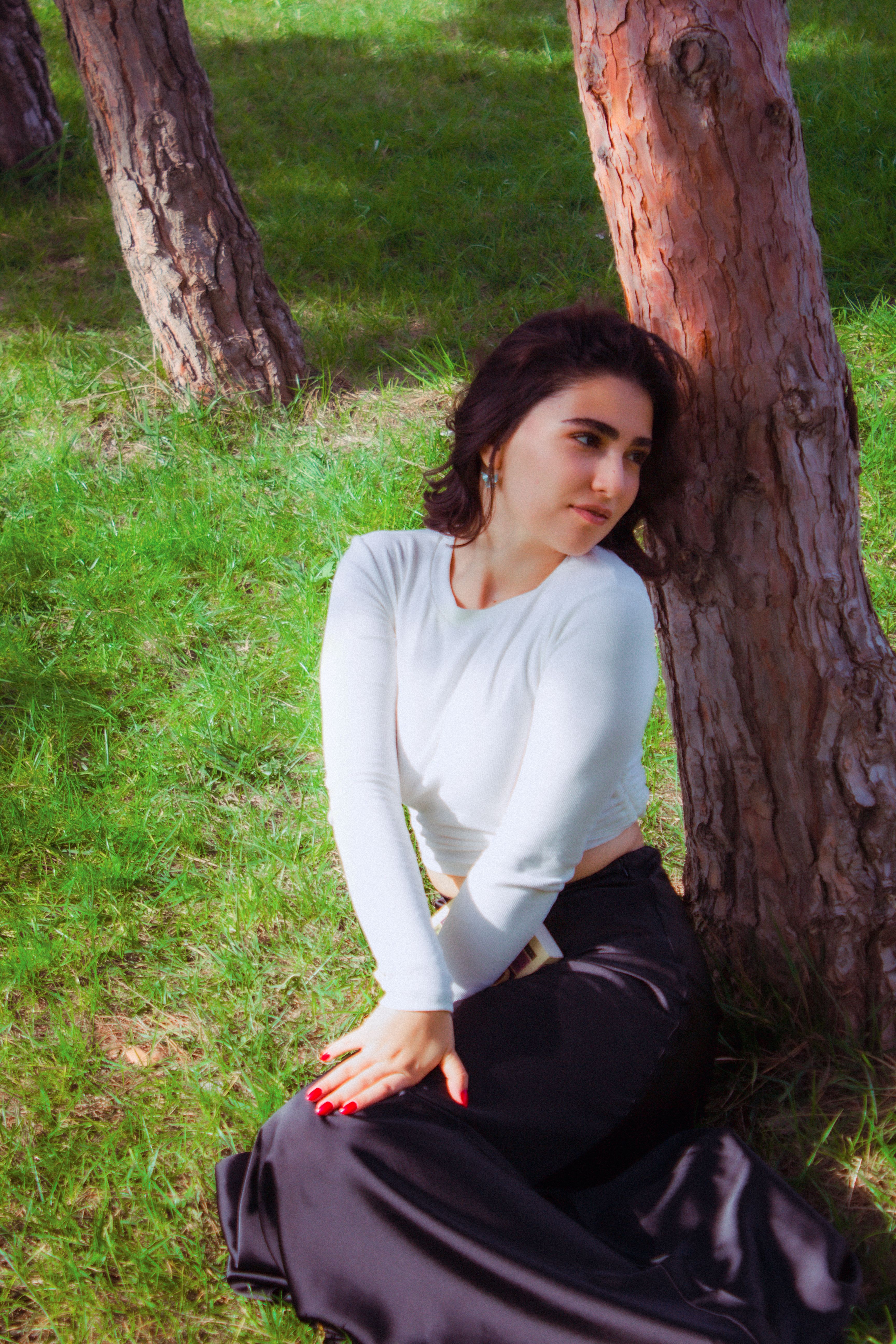 Young Woman Sitting under a Tree in a Park · Free Stock Photo