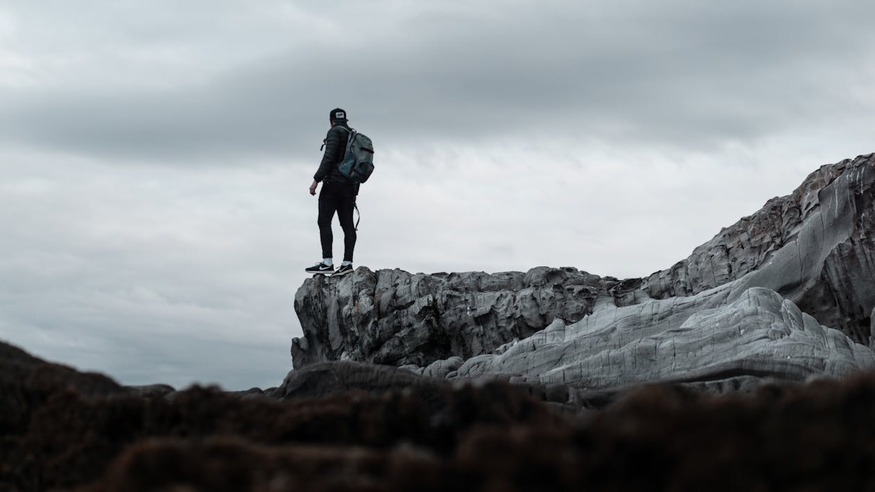 Free Man Standing on the End of the Rock Stock Photo