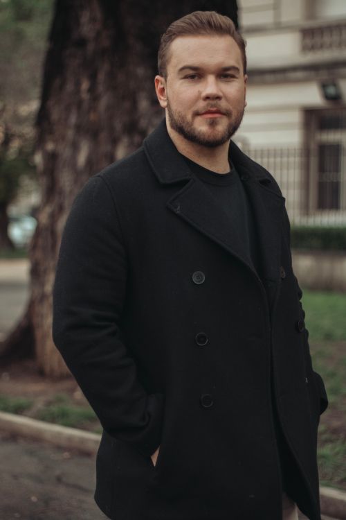 Free Portrait of a bearded man in black pea coat on city street. Urban fashion and style. Stock Photo