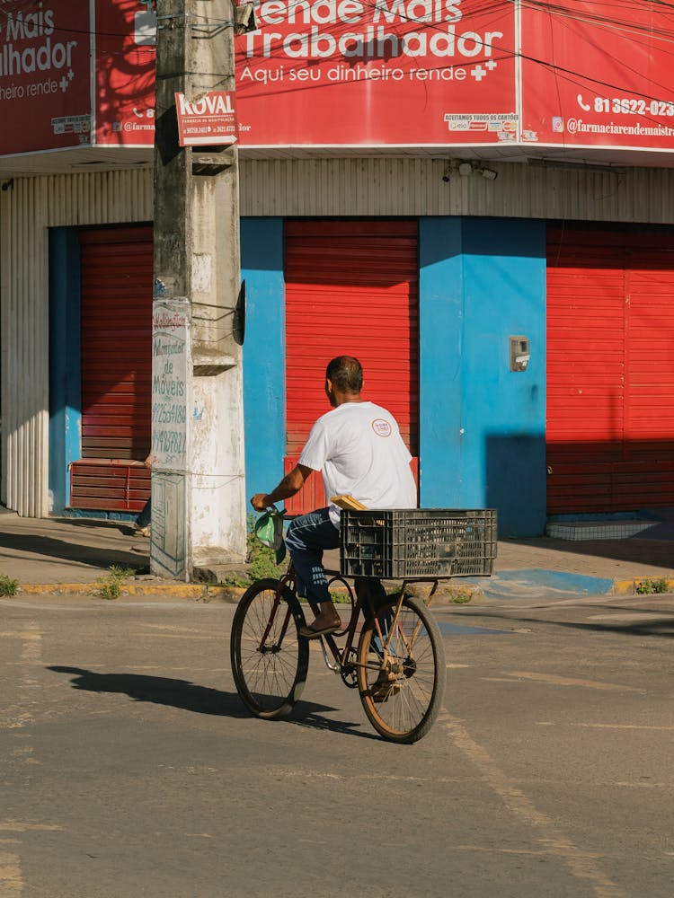 A Man On A Bike With A Box