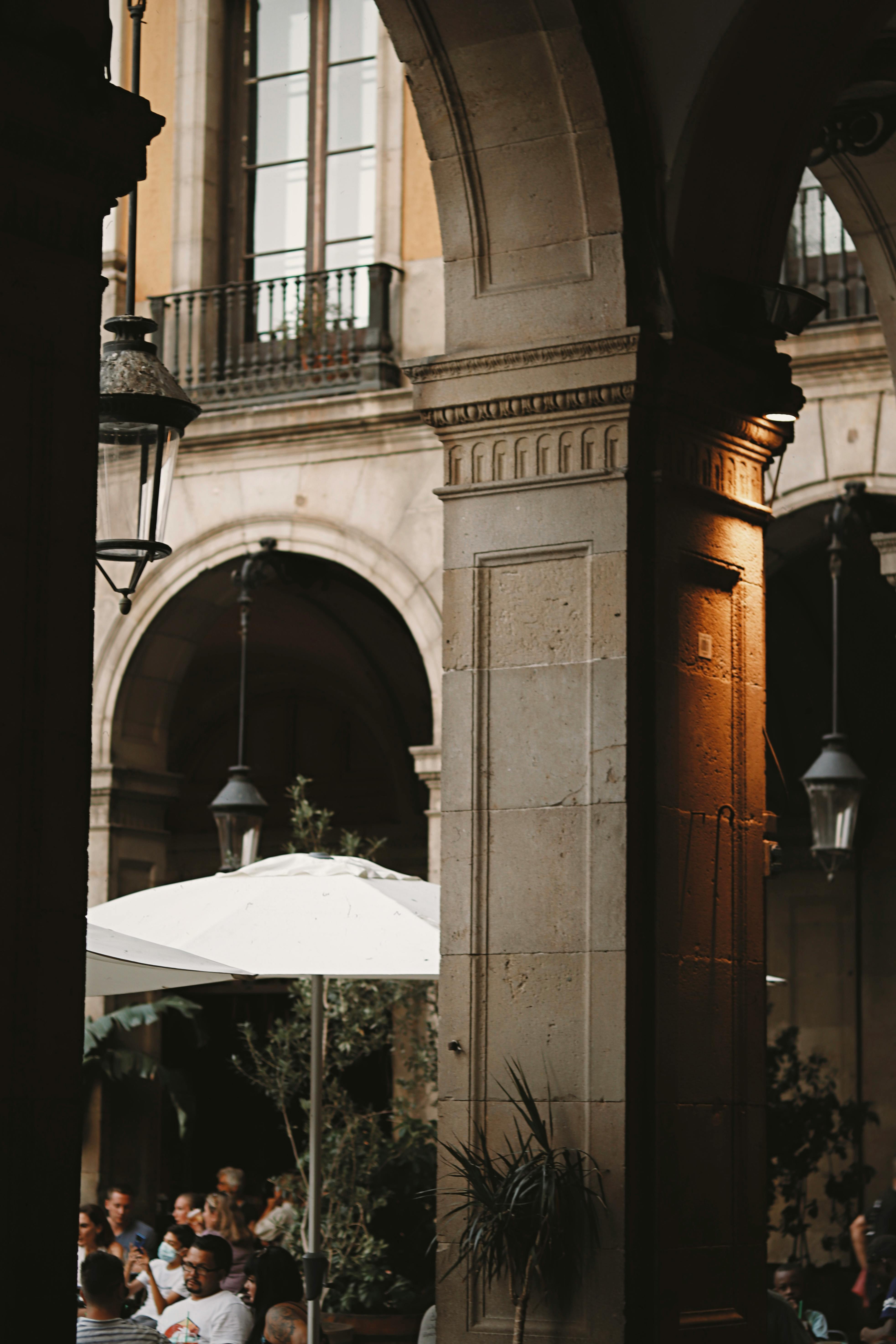 a couple sitting under an archway at a restaurant