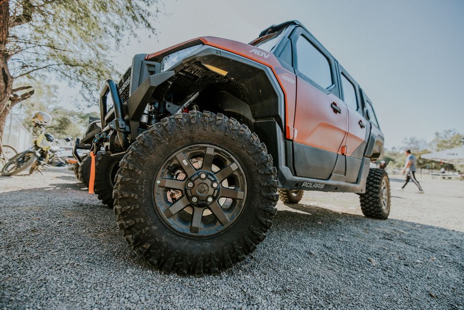Dynamic low-angle shot of a rugged offroad vehicle ready for adventure, showcasing its robust tires and design.