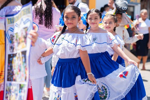 Girls in Traditional Costumes Dancing at a Parade 