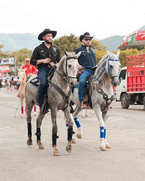 Men Riding on Horseback on the Street 