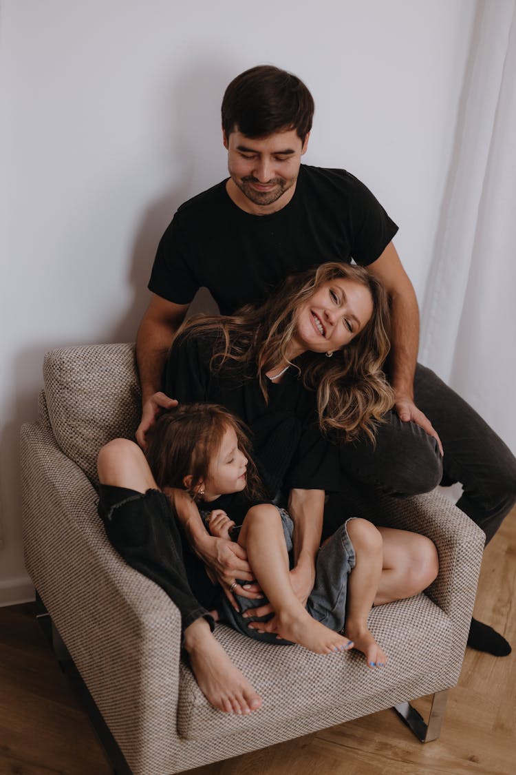 Father, Mother And Daughter Sitting Together