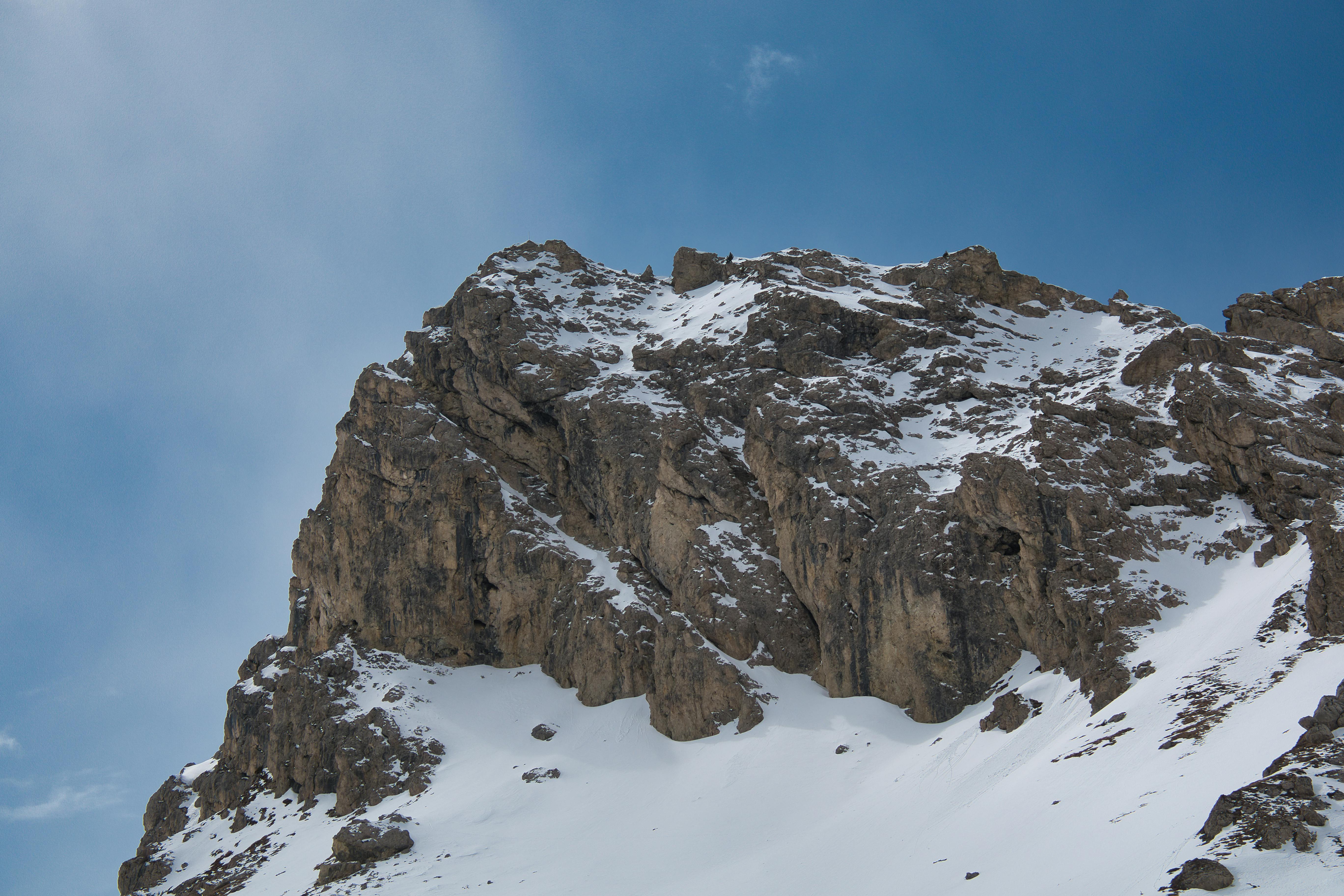 Prescription Goggle Inserts - Majestic snow-covered rocky mountain peak with a bright blue sky backdrop.