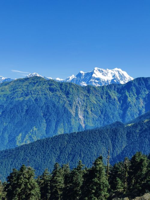 Free A breathtaking view of the Himalayas in Rudraprayag, India with lush green forests and snow-capped peaks. Stock Photo