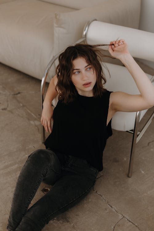 Brunette Woman in Black Fixing Hair