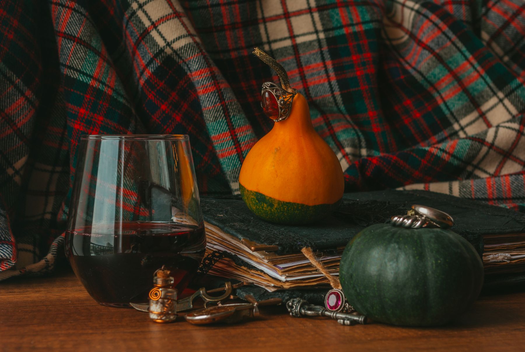 Deep late-fall interior detail with textiles and pumpkins