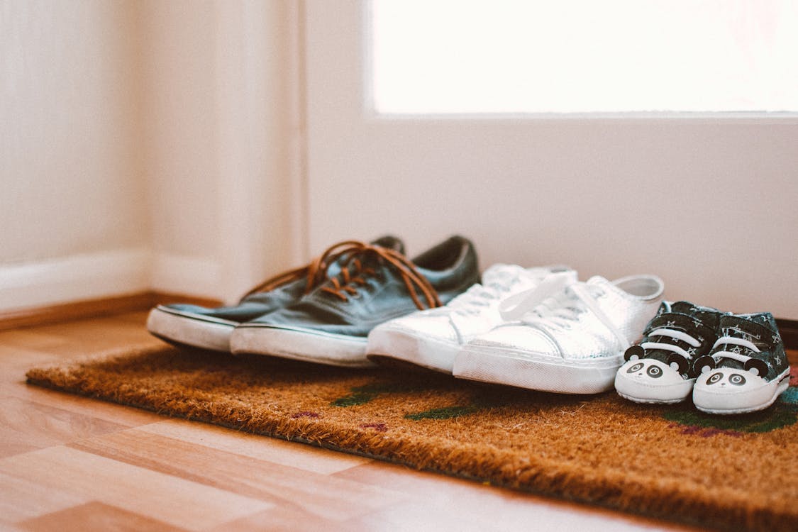 shoes placed on mat at the front door area of a home 