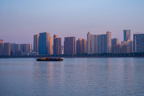 Container Ship Sailing on City Coast